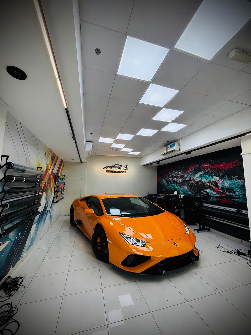 Orange Lamborghini Huracán in White Diamond studio